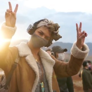 woman wearing Sound Off headphones at an outdoor festival in Peru