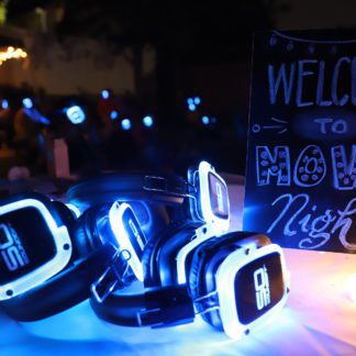 Glowing Sound Off headphones next to movie night sign