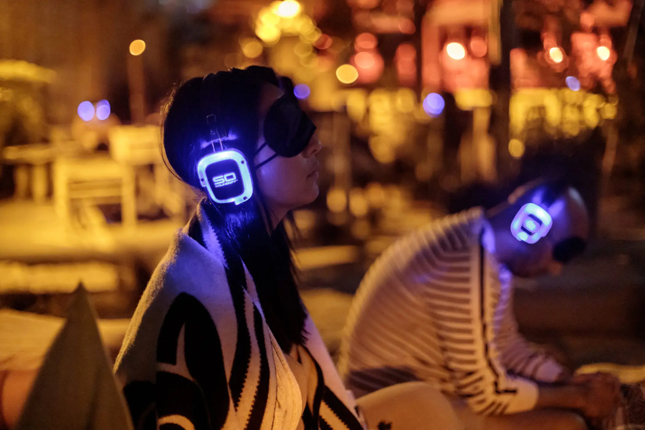 Participants wearing Sound Off headhphones at new moon ceremony