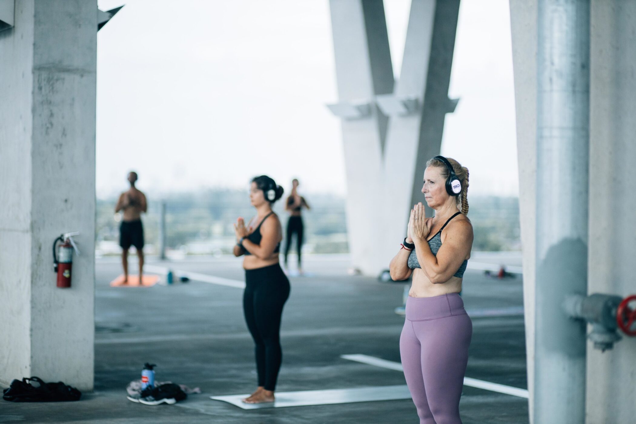 Yoga students wearing Sound Off headphones at an outdoor class