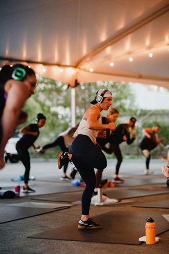 GOAT Santa Cruz fitness class students wearing silent disco headphones