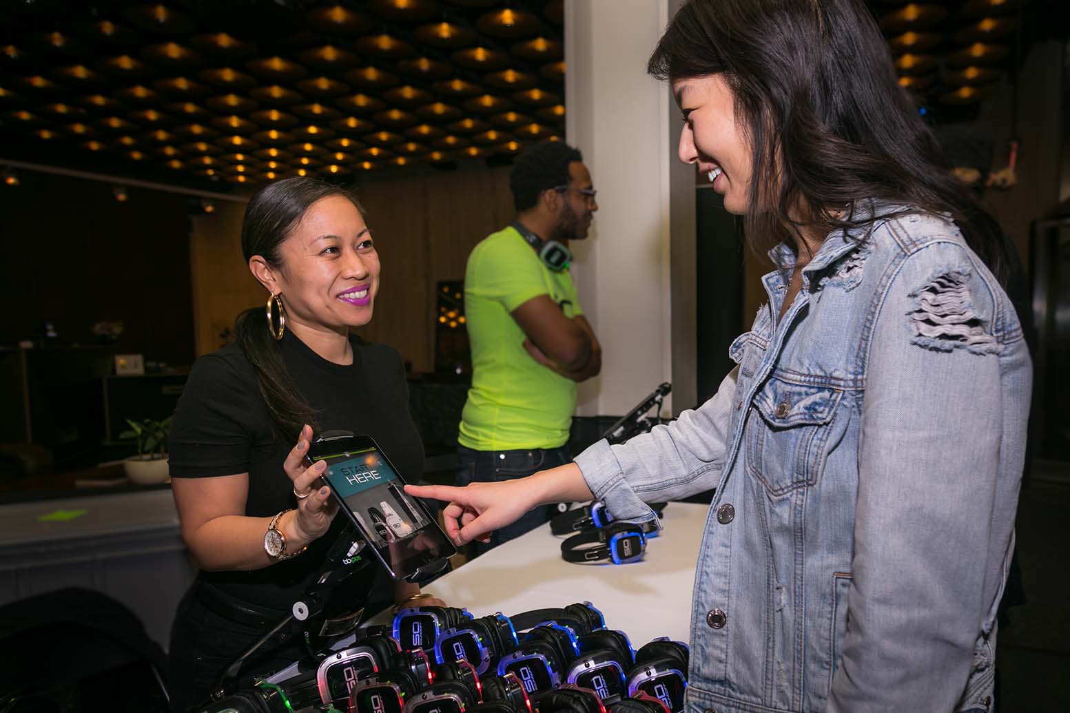 Attendee checks out Sound Off headphones at a staffed event