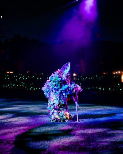 Puppet and green-glowing silent disco headphones at The Cortège